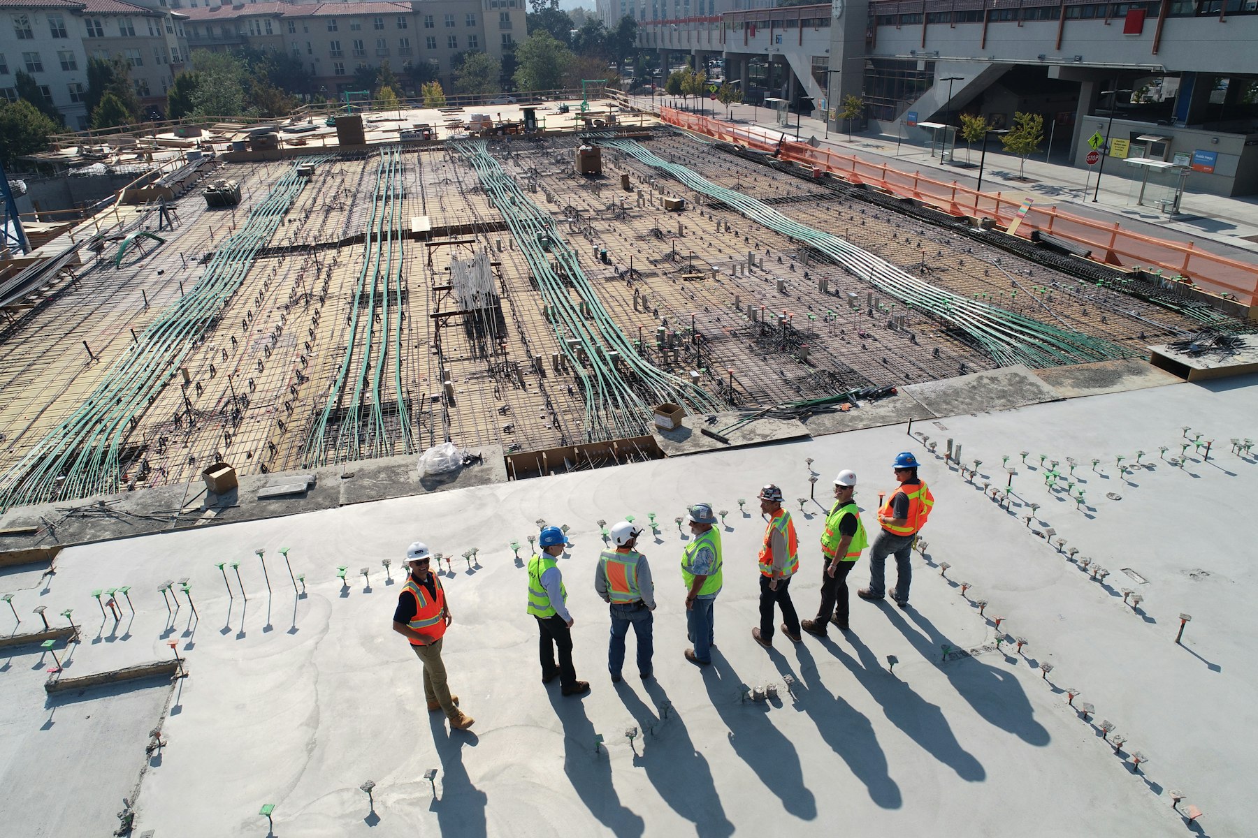 A crew in hi-vis and hard hats lined up on a job site